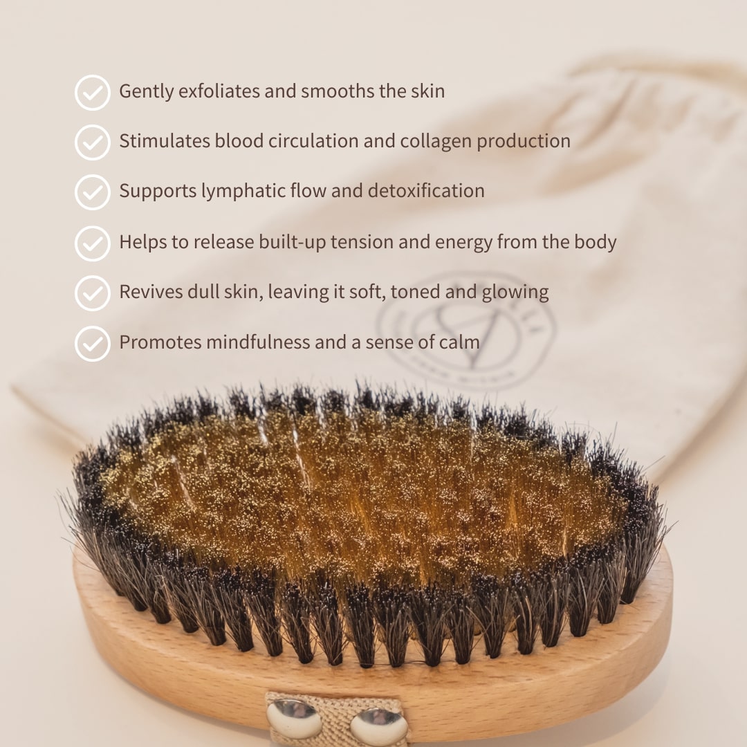 Close-up of an Arella copper body brush beside a list of body-brushing benefits