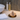 Body brush resting on a copper dish in a luxurious neutral bathroom setting