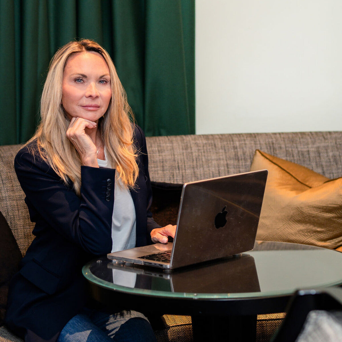 Arella founder Laura Capewell seated beside her laptop