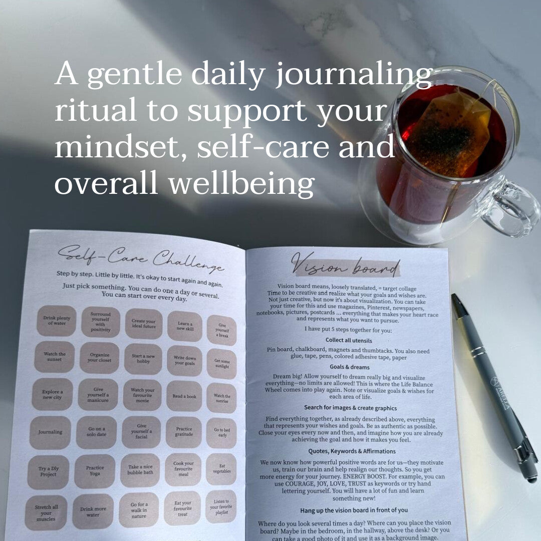 Open Arella journal showing daily prompts and a mood tracker beside a cup of tea