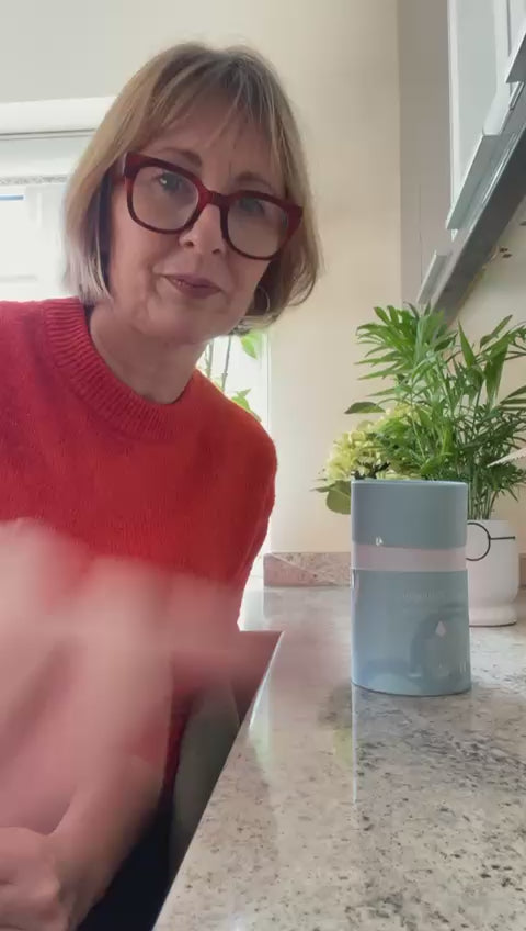 Christina speaking beside an Arella Collagen tin